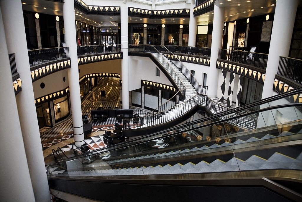 Atrium of a mall with multiple stairs and escalators